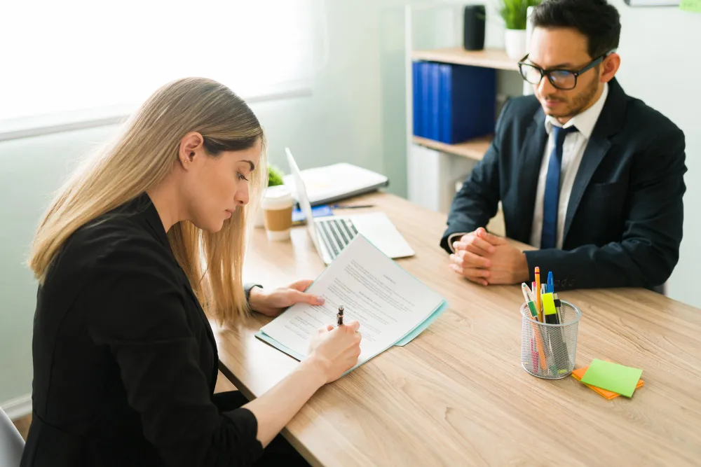 Client reviewing a clear agreement with a solicitor.